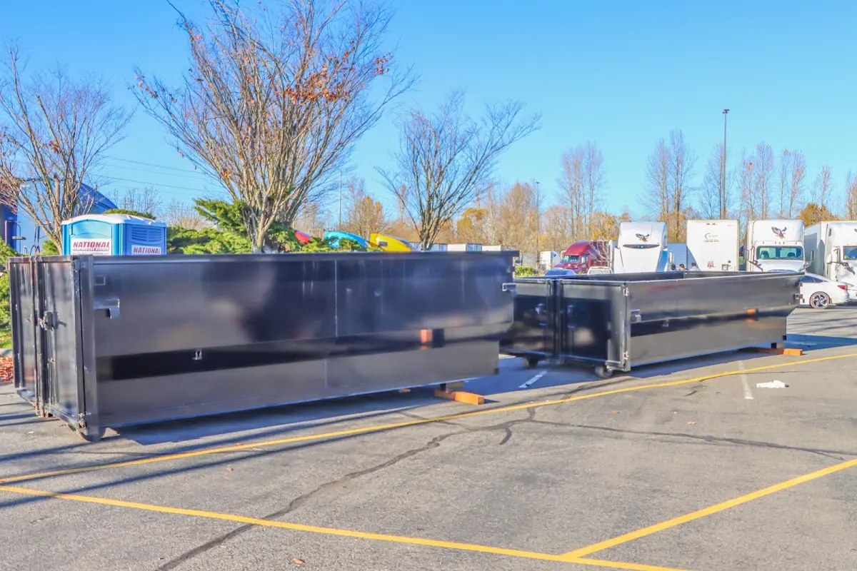 Professional dumpster rental service with roll-off container on residential driveway in Clarksburg